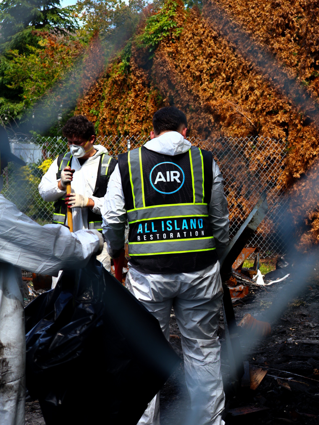All Island Restoration team in hazmat gear performing post-fire debris cleanup