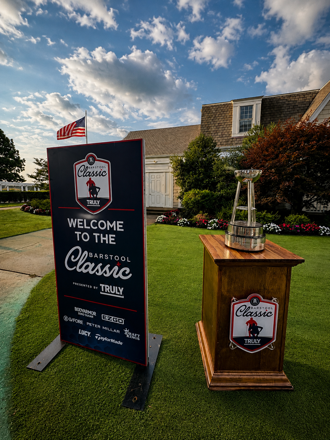 Welcome sign and championship trophy at the Barstool Classic golf tournament presented by Truly